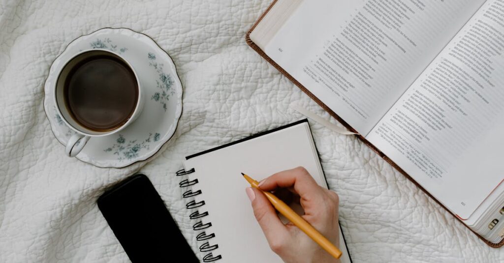 pexels-photo-8383484-8383484 Handwriting on notebook with open book and coffee in bed. Perfect cozy setup for reading or studying.